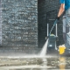 man pressure washing outdoor pavers